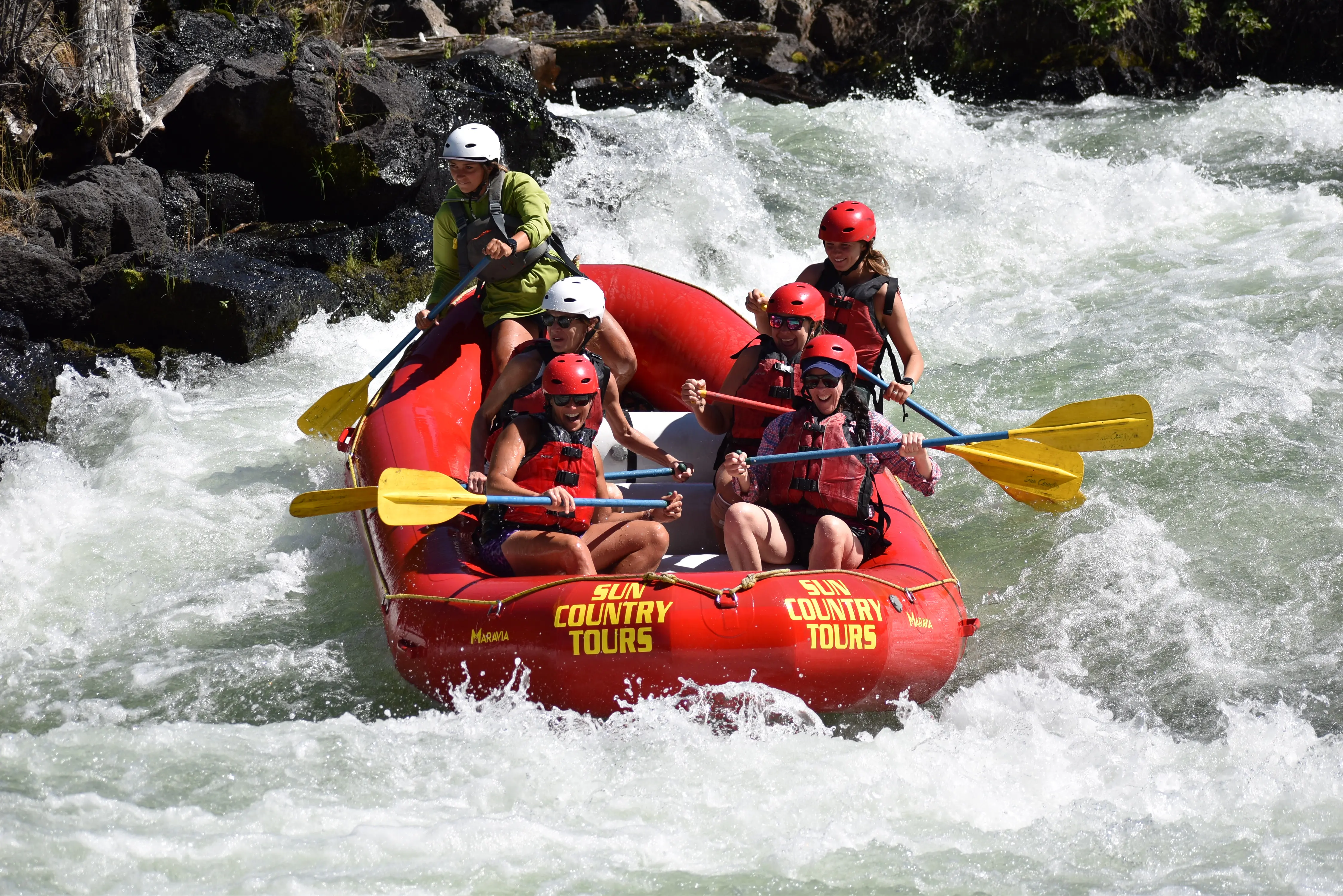 Whitewater raft navigating river rapids