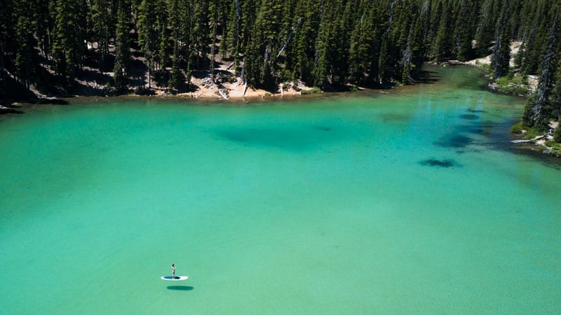 Alpine lake surrounded by forested mountains